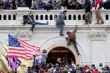 FILE PHOTO: A mob of supporters of U.S. President Donald Trump fight with members of law enforcement at a door they broke open…