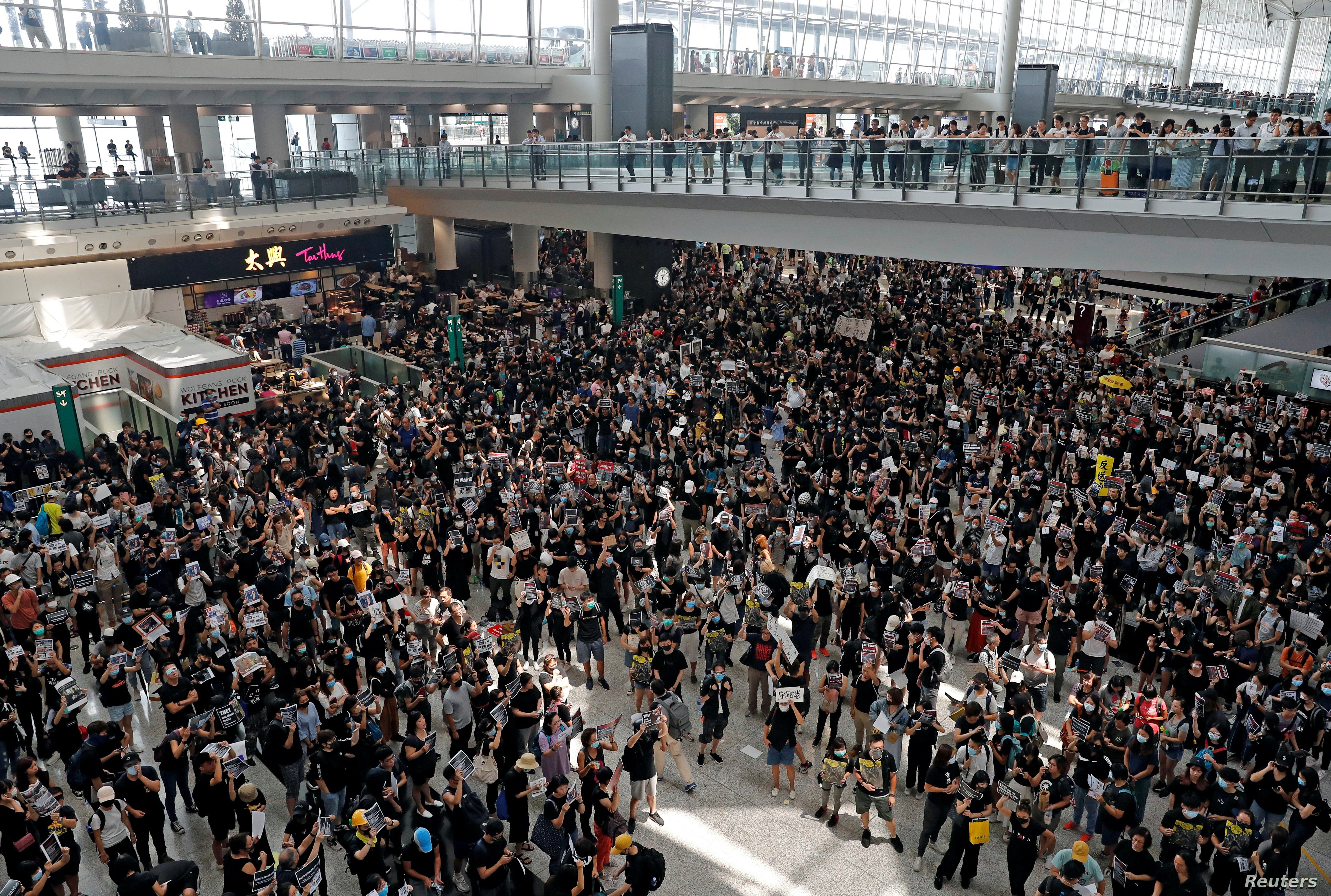 Anti-extradition bill protesters attend a mass demonstration at Hong Kong International Airport, Aug. 12, 2019.