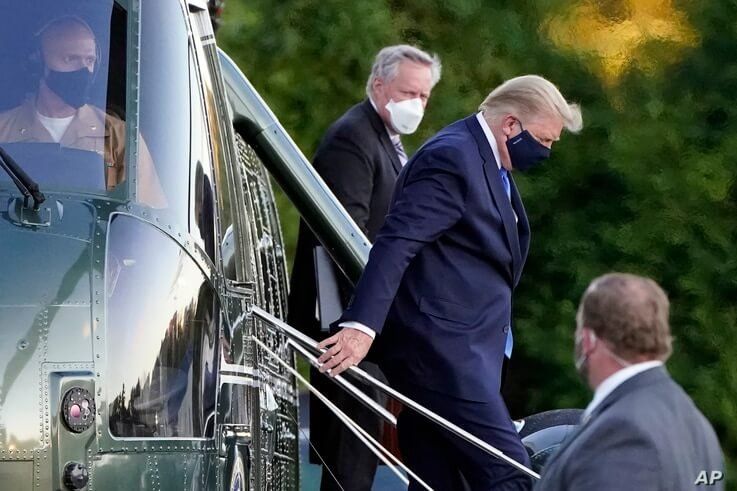 President Donald Trump arrives at Walter Reed National Military Medical Center, in Bethesda, Md., Friday, Oct. 2, 2020, on…