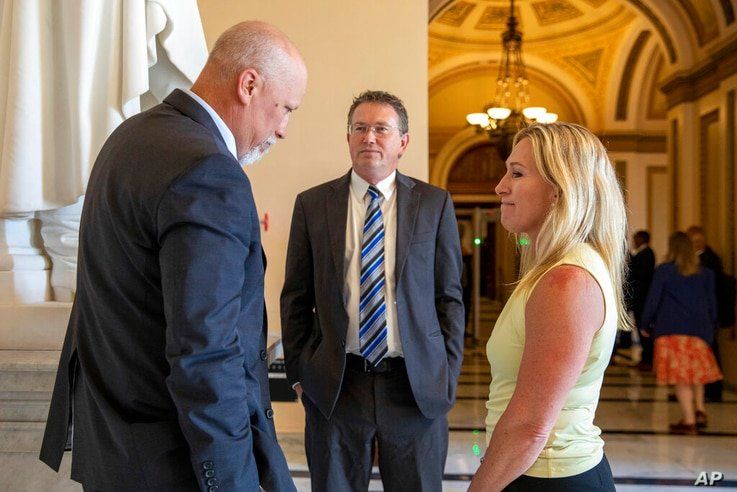 From left, Rep. Chip Roy, R-Texas, Rep. Thomas Massie, R-Ky., and Rep. Marjorie Taylor Greene, R-Ga. talk on Capitol Hill in…