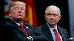 FILE - President Donald Trump sits with Attorney General Jeff Sessions during an FBI National Academy graduation ceremony in Quantico, Virginia, Dec. 15, 2017.