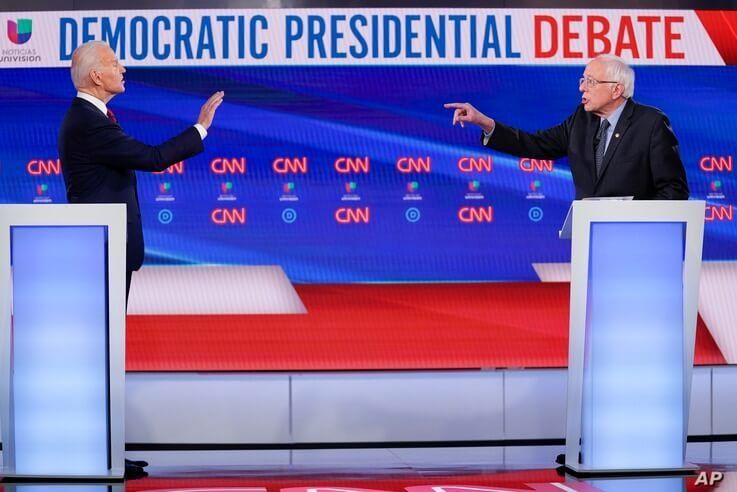 Former Vice President Joe Biden, left, and Sen. Bernie Sanders, I-Vt., right, participate in a Democratic presidential primary…