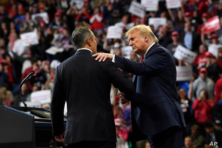 President Donald Trump, left, talks to Kentucky Gov. Matt Bevin, right, during a campaign rally in Lexington, Ky., Monday, Nov…