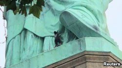 A protester is seen on the Statue of Liberty in New York, July 4, 2018, in this picture obtained from social media. (Danny Owens/via Reuters)