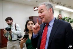 Sen. Tim Kaine, D-Va., talks with a reporter as he arrives for a vote on Gina Haspel to be CIA director, on Capitol Hill, May 17, 2018 in Washington.