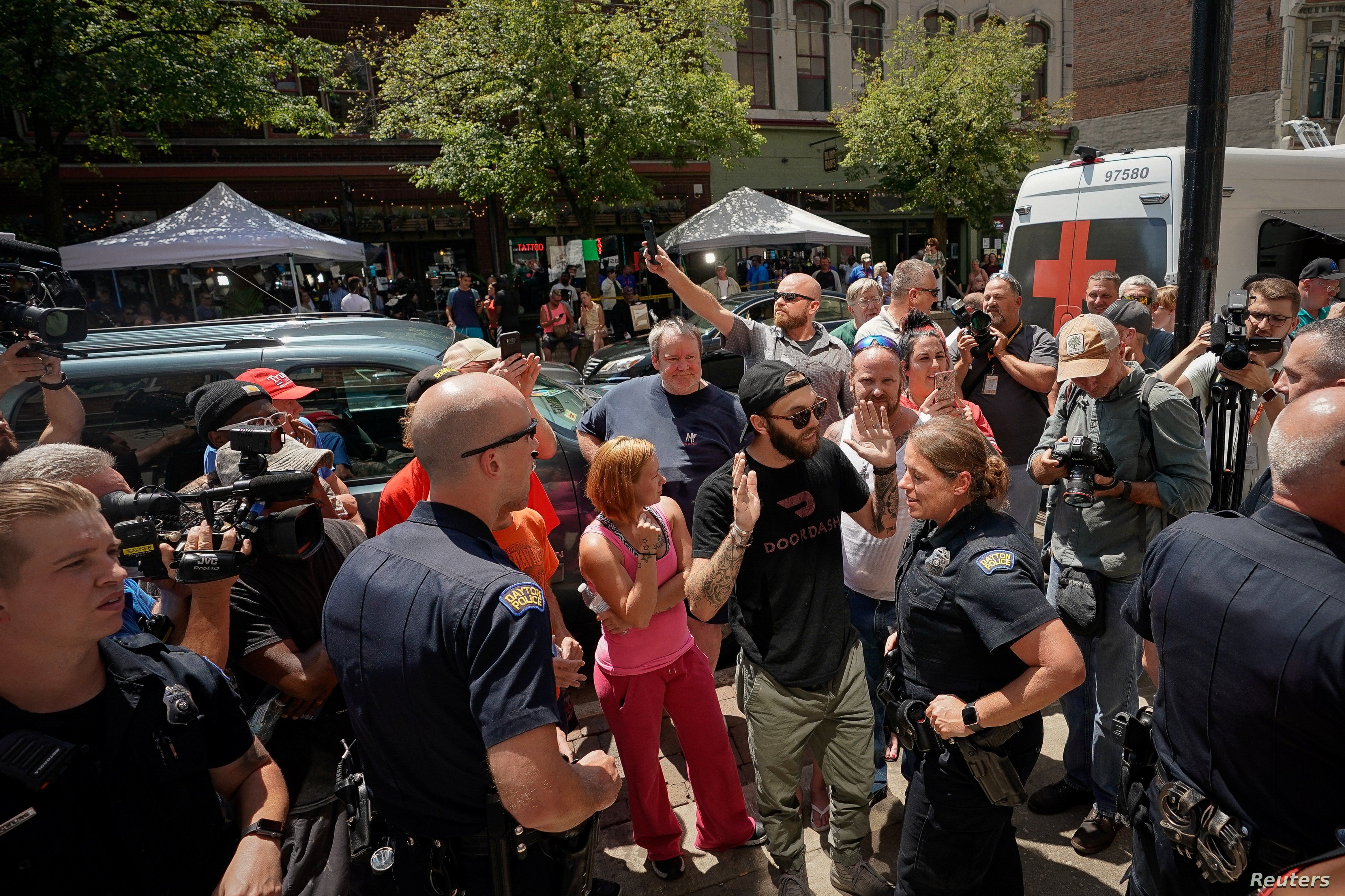 Police separate supporters of U.S. President Donald Trump from those who are opposed to the president during an argument near the site of a mass shooting in Dayton