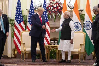 U.S. President Donald Trump and Indian Prime Minister Narendra Modi shake hands before their meeting at Hyderabad House,…