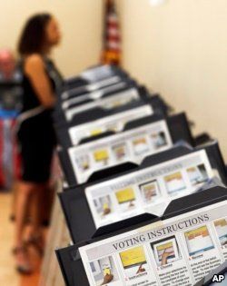 Pamela Hampton votes in Sandy Springs, Ga., May 9, 2018. As the midterm congressional primaries heat up amid warnings of Russian hacking, about 1 in 5 Americans will be voting on machines that do not produce paper records.