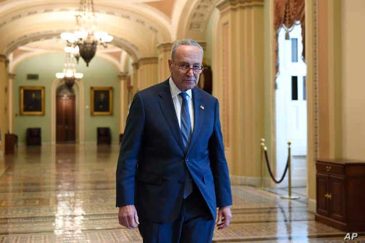 Senate Minority Leader Sen. Chuck Schumer of N.Y., walks on Capitol Hill in Washington, Friday, Jan. 3, 2020. (AP Photo/Susan…