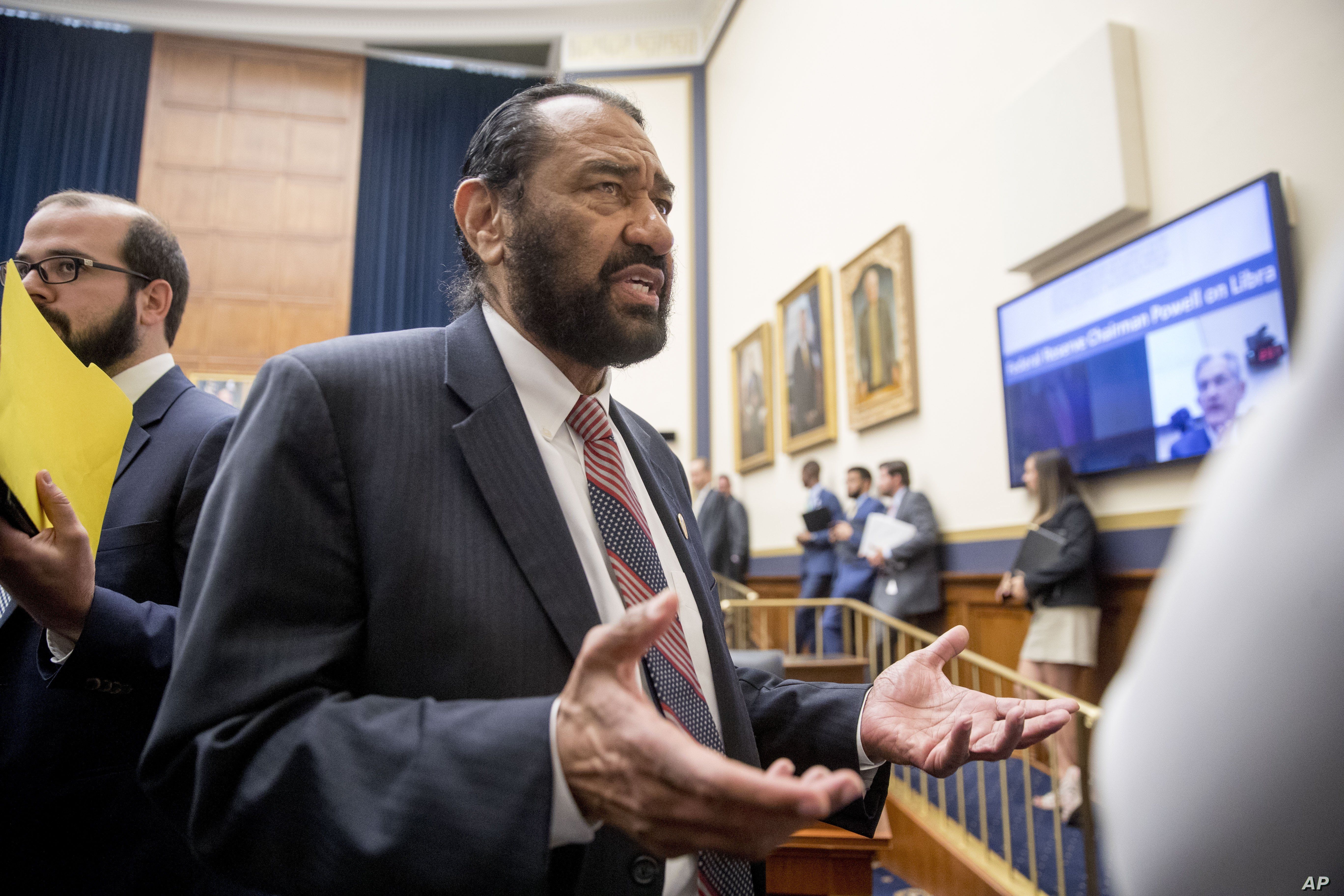  Rep. Al Green, D-Texas, right, speaks to visitors during a break from testimony before a House Financial Services Committee on Capitol Hill in Washington, July 17, 2019. Green has introduced a resolution in the House to impeach President Donald Trump.