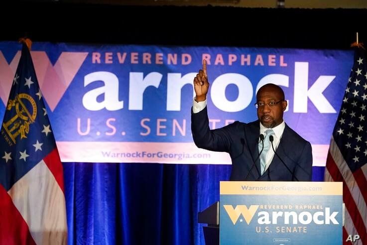 Raphael Warnock, a Democratic candidate for the U.S. Senate speaks during a rally, Tuesday, Nov. 3, 2020, in Atlanta. (AP Photo…