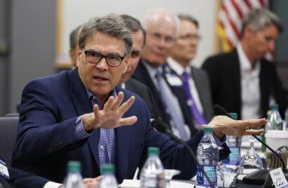 Energy Secretary Rick Perry, left, speaks at a roundtable discussion among the government agencies, the private sector and…