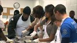 Obama honors MLK holiday, visits soup kitchen