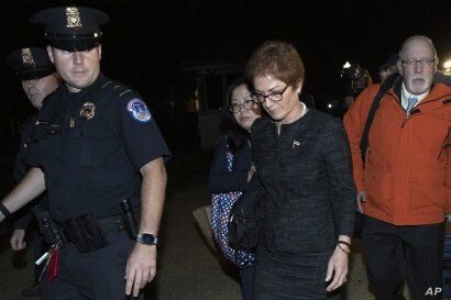 Former U.S. ambassador to Ukraine Marie Yovanovitch, center, leaves Capitol Hill, Friday, Oct. 11, 2019, in Washington, after…