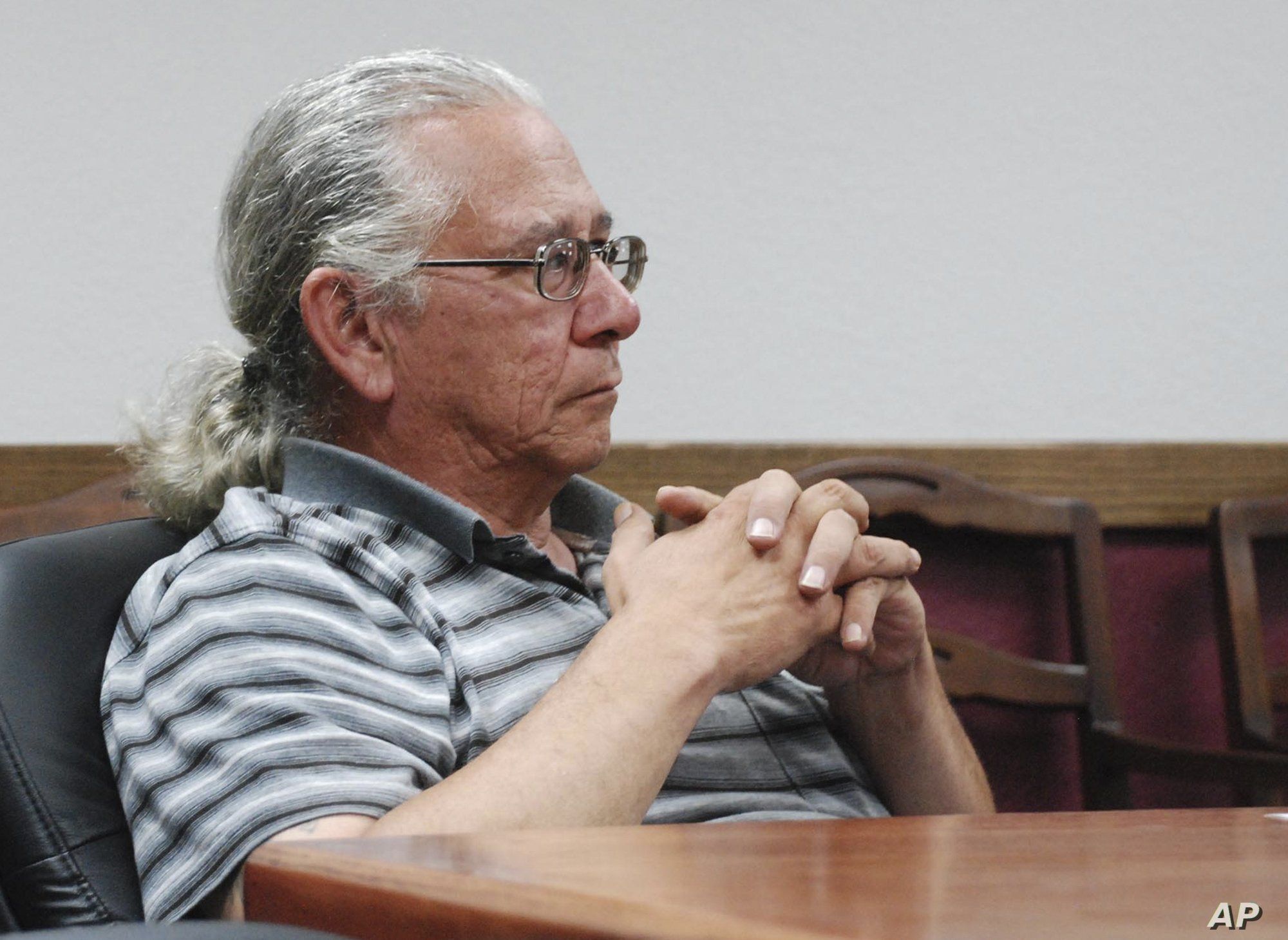 FILE - In this July 31, 2013 photo, O.J. Semans, of Rosebud, S.D., executive director of the voting advocacy group Four Directions, listens in Pierre, S.D., as the South Dakota Election Board discusses a proposal to use federal money to set up satell...