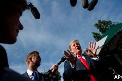 President Donald Trump speaks to reporters at the White House, June 15, 2018, in Washington.