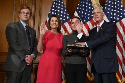 House Speaker Nancy Pelosi of Calif., second from left, poses during a ceremonial swearing-in with Rep. Francis Rooney, R-Fla., right, on Capitol Hill in Washington, Jan. 3, 2019.