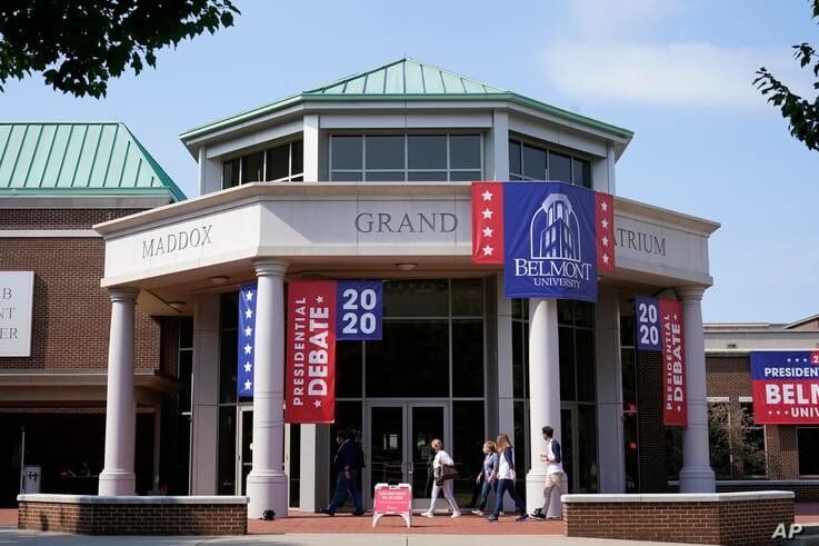 People walk outside the Curb Event Center at Belmont University as preparations are underway for the second and final presidential debate of the 2020 campaign, in Nashville, Tennessee, Oct. 20, 2020.