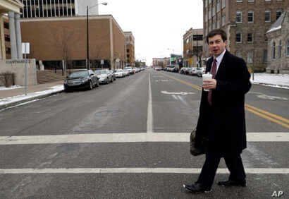 Mayor Pete Buttigieg talks with an AP reporter as he walks in downtown South Bend, Ind., Thursday, Jan. 10, 2019.  Few people…