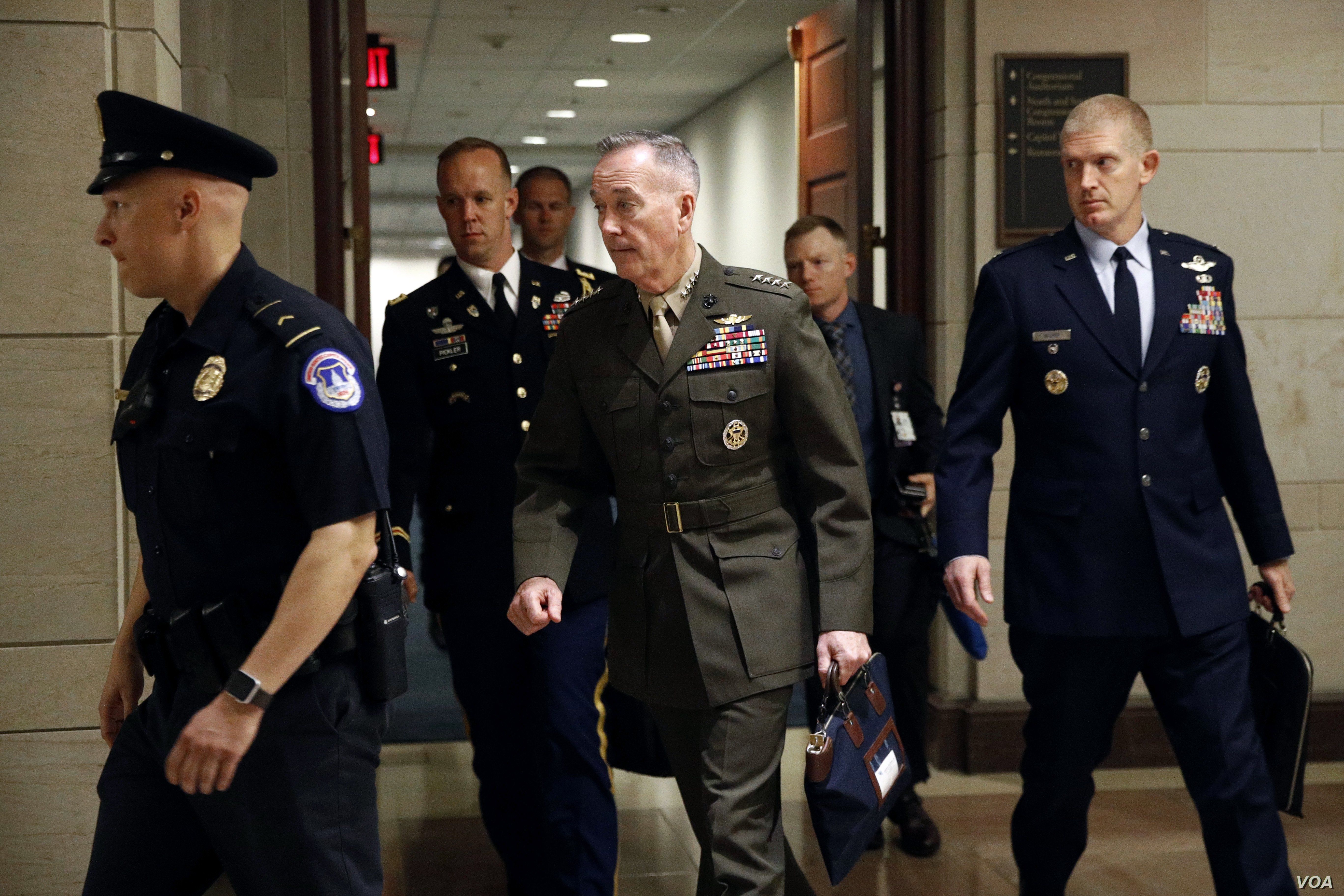 Joint Chiefs Chairman Gen. Joseph Dunford, center, walks to a classified briefing for members of the U.S. Senate on Iran, on Capitol Hill in Washington, May 21, 2019. 