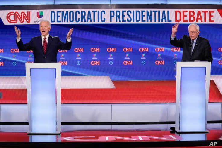 Former Vice President Joe Biden, left, and Sen. Bernie Sanders, I-Vt., right, participate in a Democratic presidential primary…