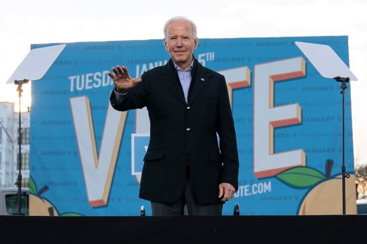 President-elect Joe Biden waves from the stage as he campaigns for for Georgia Democratic candidates for U.S. Senate, Rev…