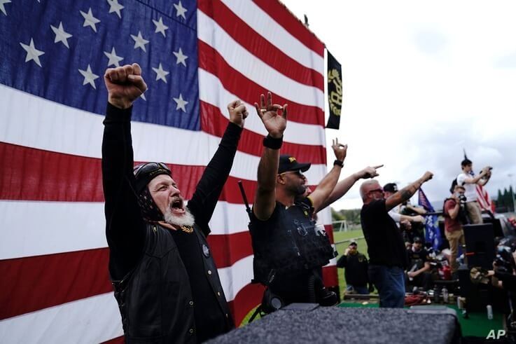 Members of the Proud Boys cheer on stage as they and other right-wing demonstrators rally, Saturday, Sept. 26, 2020, in…