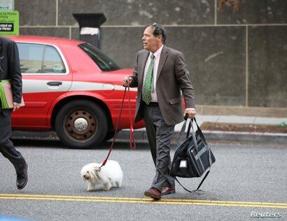 Randy Credico, an associate of former Trump campaign adviser Roger Stone, walks with his pet dog as he arrives to testify…