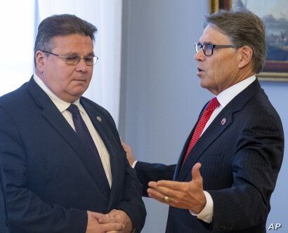 U.S. Energy Secretary Rick Perry, right, speaks to the Lithuania's Foreign Minister Linas Linkevicius. 