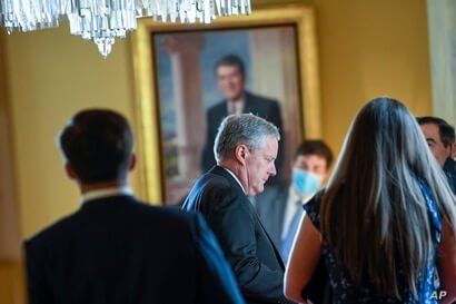 White House Chief of Staff Mark Meadows, center, waits in the office of Senate Majority Leader Mitch McConnell of Ky., on…