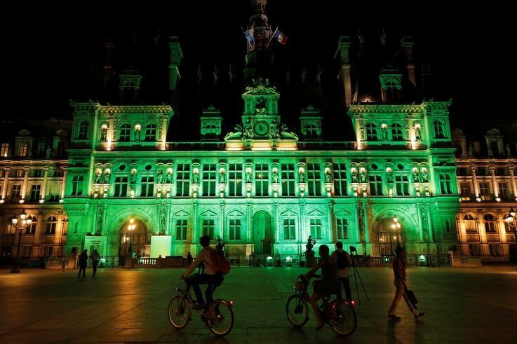 FILE PHOTO: Green lights are projected onto the facade of the Hotel de Ville in Paris, France, after U.S. President Donald Trump announced his decision that the United States will withdraw from the Paris Climate Agreement