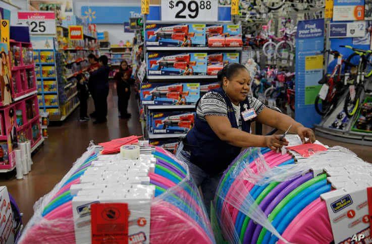 Balo Balogun labels items in preparation for a holiday sale at a Walmart Supercenter, Wednesday, Nov. 27, 2019, in Las Vegas…