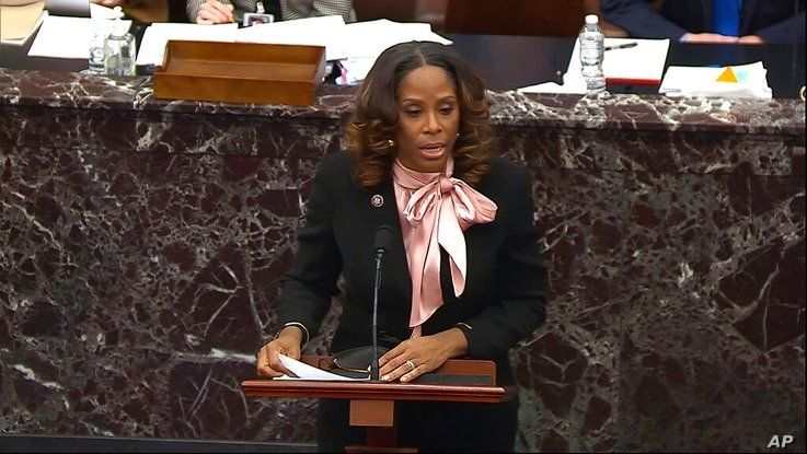 In this image from video, House impeachment manager Del. Stacey Plaskett, D-Virgin Islands, answers a question from Sen. Bob…
