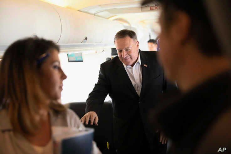 FILE - U.S. Secretary of State Mike Pompeo walks towards reporters to speak aboard his plane en route to Thailand
