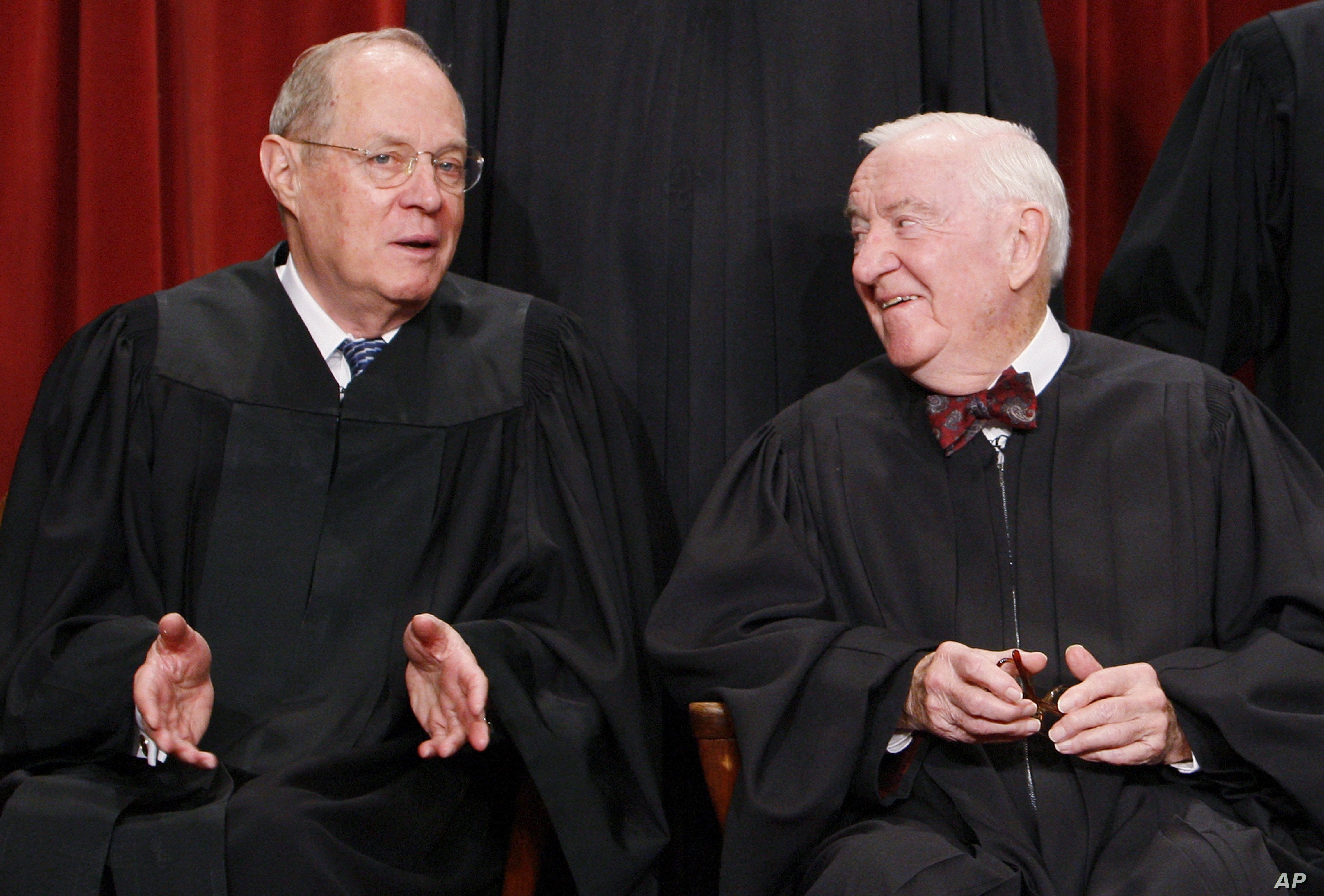 Associate Justices Anthony Kennedy, left, and John Paul Stevens talk to each other as they sit for a new group photograph with other Supreme Court judges, Tuesday, Sept. 29, 2009, at the Supreme Court in Washington. 