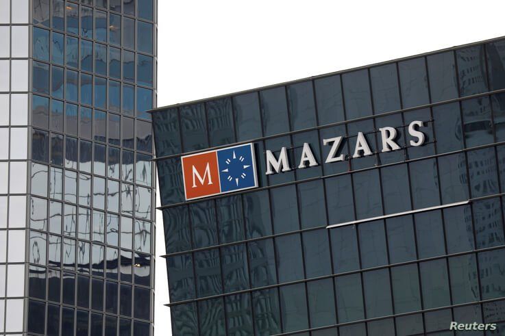 FILE - The logo of Mazars, an international organization that specializes in audit, accounting, tax and advisory services, is seen on a building in the financial district of La Defense near Paris, May 14, 2018.