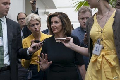 Speaker of the House Nancy Pelosi, D-Calif., is surrounded by reporters as she arrives to meet with her caucus at the Capitol in Washington, after declaring she will launch a formal impeachment inquiry against President Donald Trump.