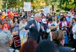 FILE - House Minority Whip Steny Hoyer, D-Md., center, speaks to immigrant rights supporters at the U.S. Capitol in Washington, Sept. 26, 2017.