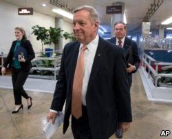 Sen. Dick Durbin, D-Ill., followed by Sen. Bob Menendez, D-N.J., walks to the Senate as Congress moves closer to the funding deadline to avoid a government shutdown, at the Capitol in Washington, Jan. 18, 2018.