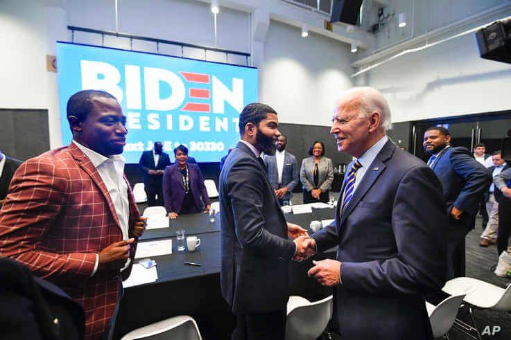 FILE - In this Nov. 21, 2019, file photo, Democratic presidential candidate former Vice President Joe Biden, right, walks…