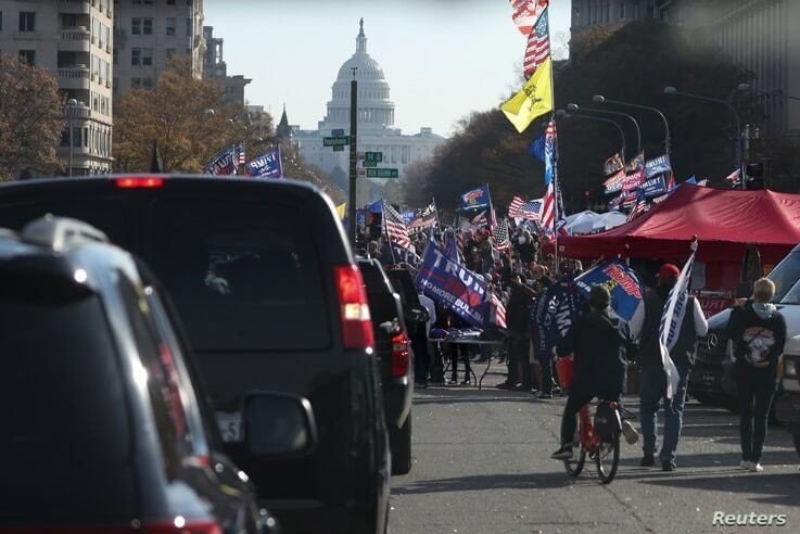 Supporters of U.S. President Donald Trump cheer alongside his presidential motorcade at Freedom Plaza near the White House in Washington, Nov. 14, 2020. 