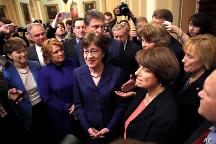 Sen. Heidi Heitkamp (2nd from left) with Sen. Susan Collins (center), Sen. Amy Klobuchar (2nd from right) at the Capitol in Washington, Jan. 22, 2018.