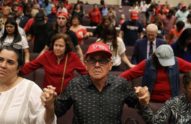 MIAMI, FLORIDA - JANUARY 03: People pray together during the 'Evangelicals for Trump' campaign event held at the King Jesus…