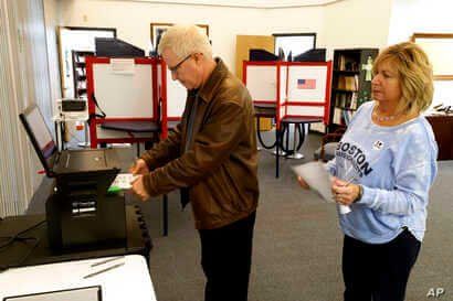 Greg Froehlinch and his wife Deb of Steubenville, Pa., take advantage of early voting, Sunday, March 15, 2020, in Steubenville,…