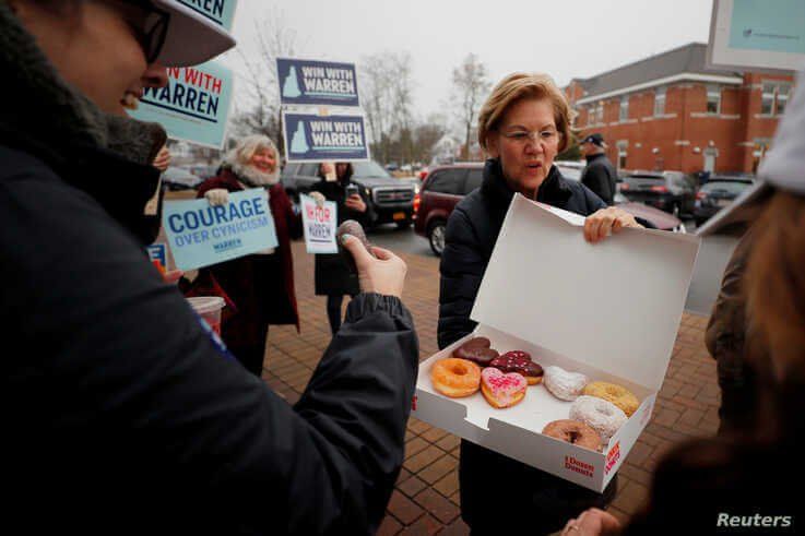 Democratic 2020 U.S. presidential candidate and U.S. Senator Elizabeth Warren (D-MA) offers donuts to supporters 