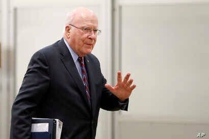 FILE - Democratic Senator Patrick Leahy waves as he arrives at the Capitol in Washington, Jan. 30, 2020.