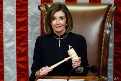 House Speaker Nancy Pelosi of Calif., smiles as she holds the gavel as the House votes on articles of impeachment against President Donald Trump by the House of Representatives at the Capitol in Washington, Dec. 18, 2019.