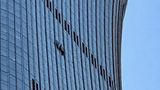 Small plane crashes into Beijing skyscraper, leaving visible hole in upper floors