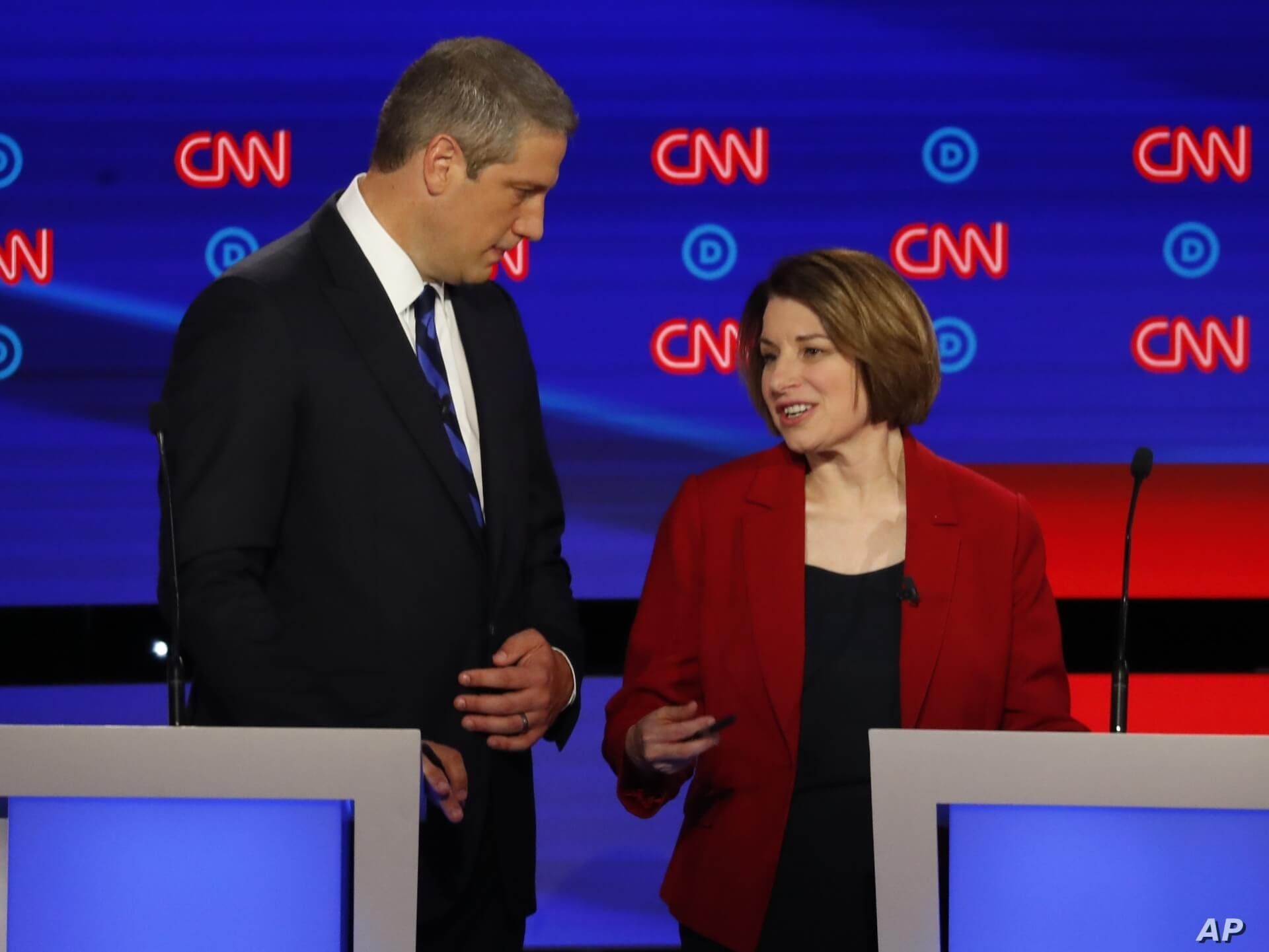 Rep. Tim Ryan, D-Ohio, and Sen. Amy Klobuchar, D-Minn. talk during a break in the first of two Democratic presidential primary debates hosted by CNN Tuesday, July 30, 2019, in the Fox Theatre in Detroit. (AP Photo/Paul Sancya)