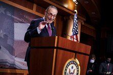 Senate Majority Leader Chuck Schumer, D-N.Y., praises his Democratic Caucus at a news conference just after the Senate narrowly…